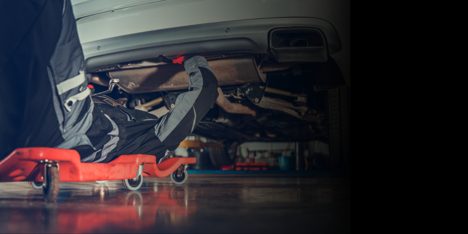 Technician under the car - Auto Service Lab